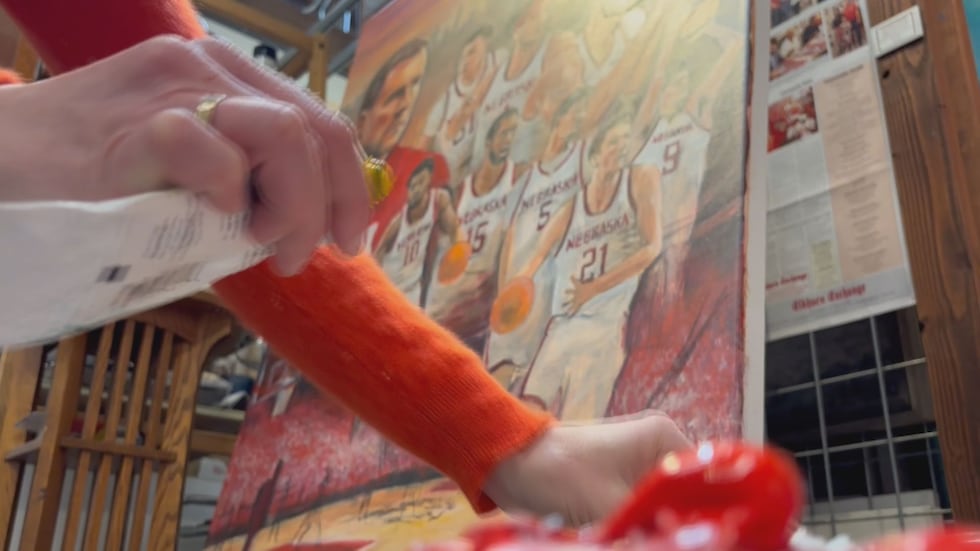 Ashley Spitsnogle, a Licensed Husker Artist, working on her piece for the basketball season at...
