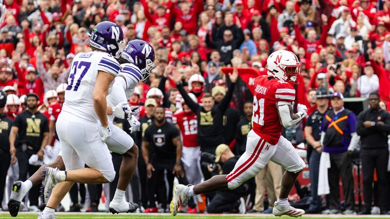 Nebraska running back Emmett Johnson (21) runs in for a touchdown against Northwestern during...